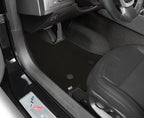 Car interior with a focus on the floor mat and door panel.