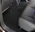 Car interior with a black floor mat on a gray car seat