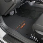 Car interior with black floor mats featuring 'Camaro' branding.