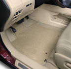 Car interior with beige floor mats on a white background
