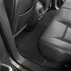 Car interior with black floor mats and gray leather seat