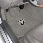 Gray car floor mat with a logo on a vehicle interior