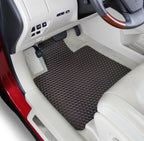Car interior with a black floor mat on a gray floor