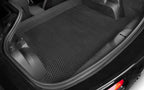 Black car mat with textured surface in a vehicle's cargo area