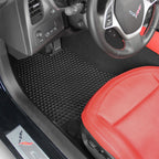 Car interior with a red seat and black floor mat.