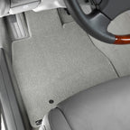 Gray car floor mat with a steering wheel in the background