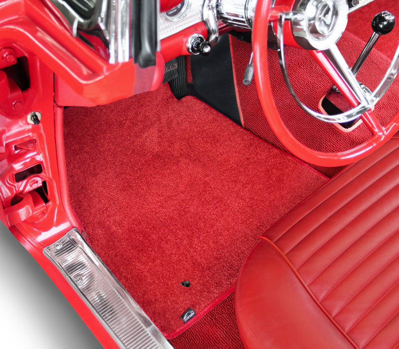 Red car interior with a steering wheel and dashboard