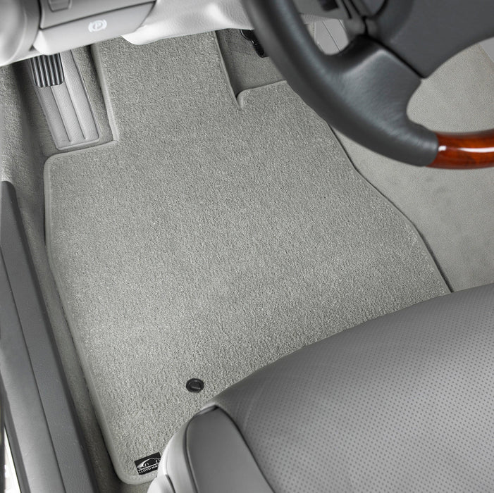 Gray car floor mat with a steering wheel in the background