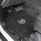 Car floor mat with Cadillac logo on a vehicle interior