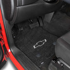 Car interior with black floor mats featuring a Chevrolet logo.