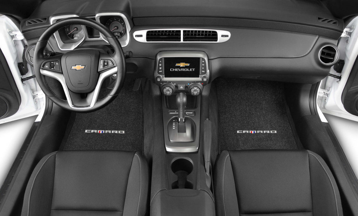 Car interior of a Chevrolet Camaro with steering wheel, dashboard, and seats.