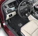 Car interior with black floor mats featuring Honda logo
