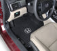 Car interior with black floor mats featuring Honda logo