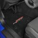 Car interior with black floor mats featuring a logo on the driver's side.