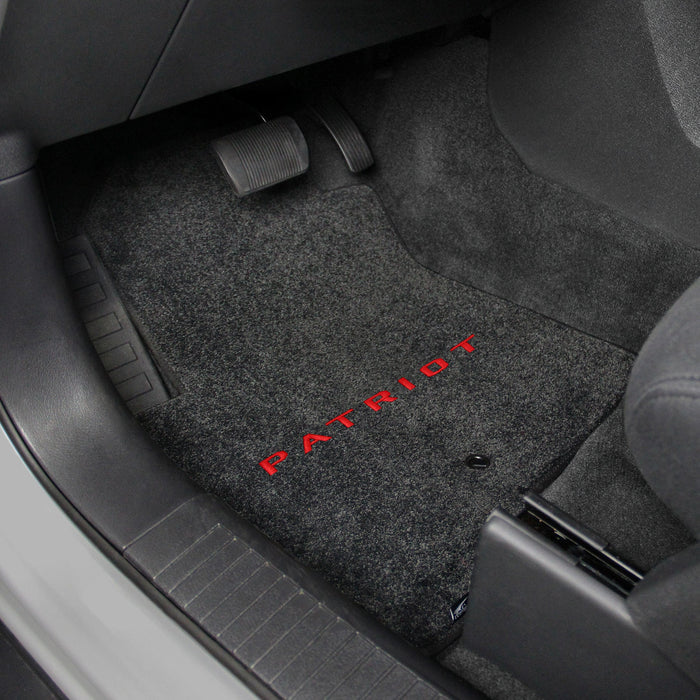 Gray car floor mat with 'Patriot' branding on a vehicle interior.