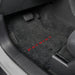 Gray car floor mat with 'Patriot' branding on a vehicle interior.