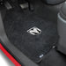 Car floor mat with a logo on a vehicle's interior