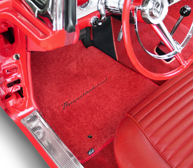 Red car interior with a 'Thunderbird' logo on the floor mat.