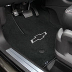 Car interior with black floor mats featuring a Chevrolet logo.