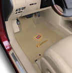Beige Cadillac logo car floor mat inside a vehicle