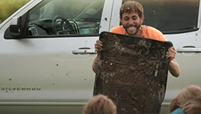 Man holding husky floor liners