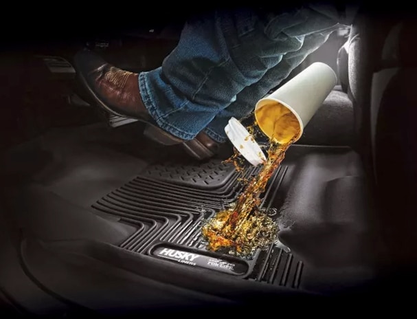 Photo showing a drink being spilled on Husky X-Act floor liners