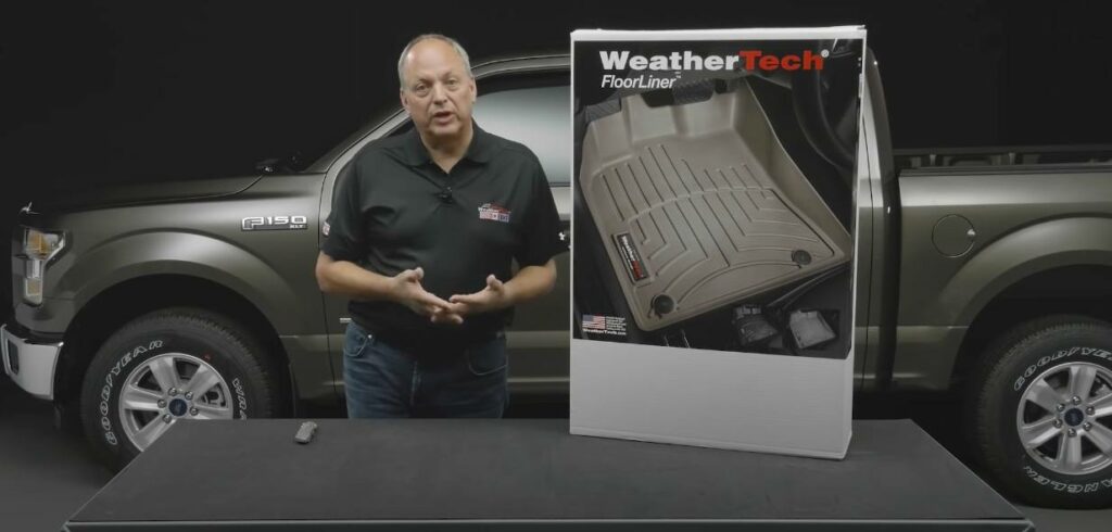 Display of WeatherTech mats in front of a Ford F-150 truck