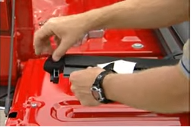 Man installing weather seals on the truck bed corner plugs