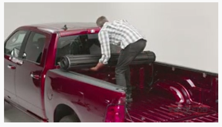 Man installing the cover on the Ram truck bed