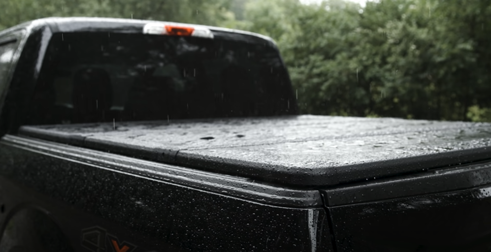 Rain pouring on a tonneau cover installed on a truck