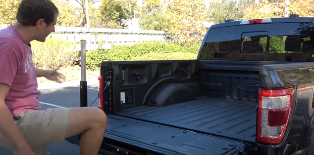 Man climbing his Ford 2021 F-150 truck bed
